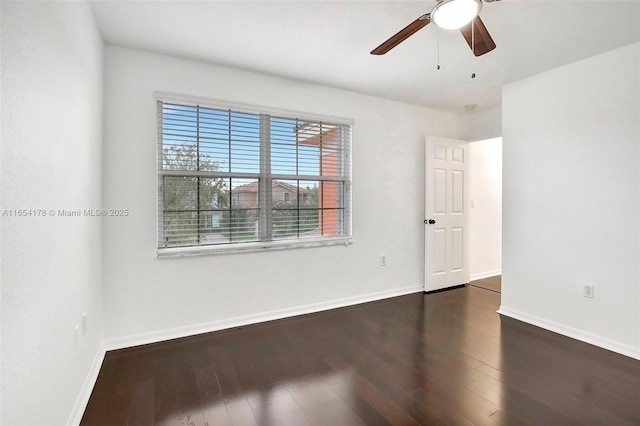 spare room with ceiling fan and dark wood-type flooring