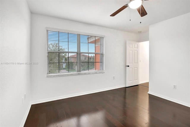 unfurnished room featuring wood finished floors, ceiling fan, and baseboards