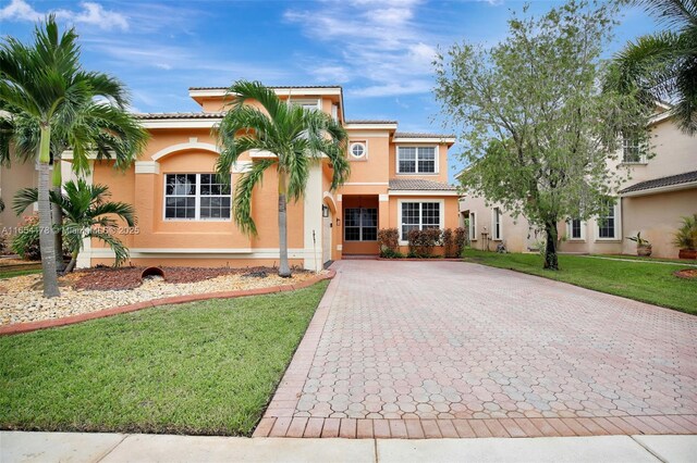 15421 SW 18th St, Miramar, FL 33027 - mediterranean / spanish home with stucco siding, a tile roof, decorative driveway, and a front yard