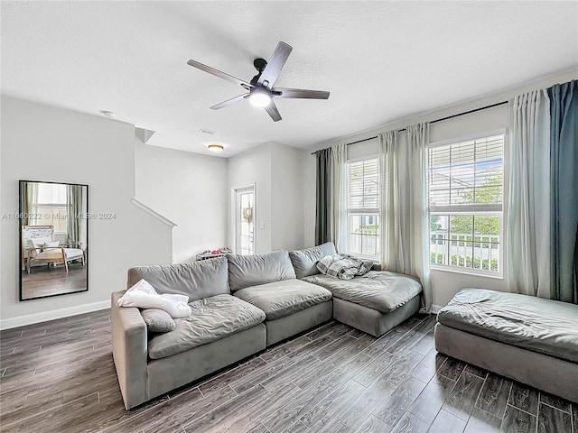 living room featuring a textured ceiling, ceiling fan, and dark hardwood / wood-style flooring