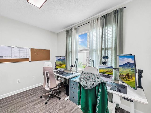 office with wood-type flooring and a textured ceiling