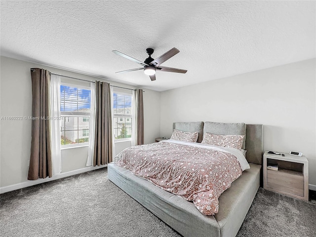 bedroom featuring a textured ceiling, ceiling fan, and dark colored carpet