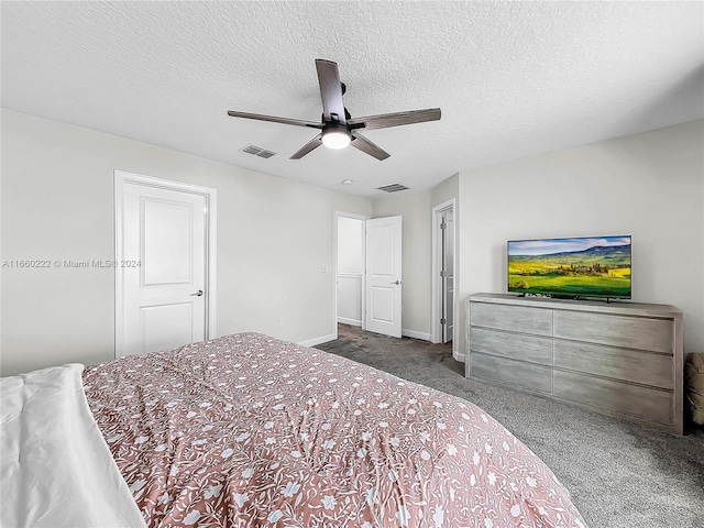 bedroom with ceiling fan, carpet, and a textured ceiling