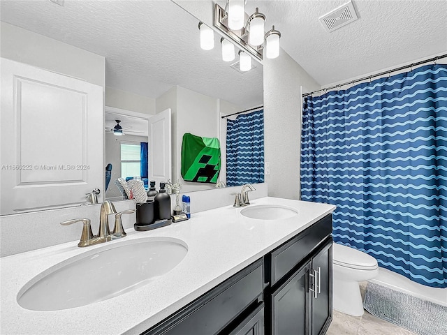 bathroom with toilet, vanity, a textured ceiling, curtained shower, and ceiling fan