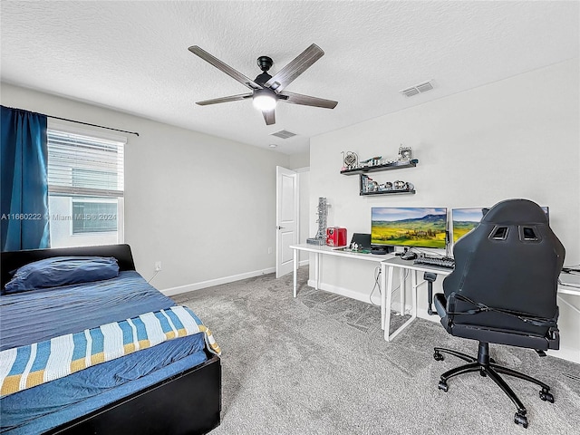 carpeted bedroom with a textured ceiling and ceiling fan