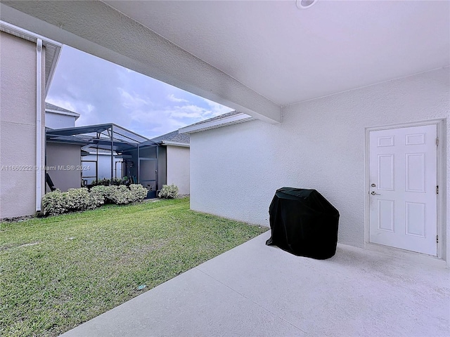 exterior space with a patio and glass enclosure