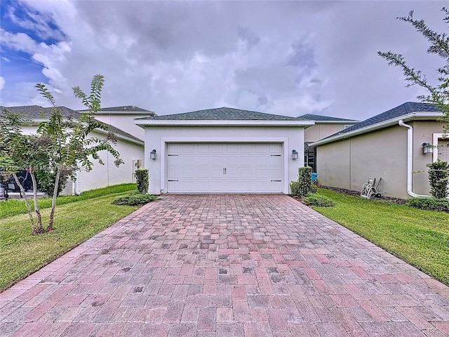 view of front of property featuring a garage and a front yard