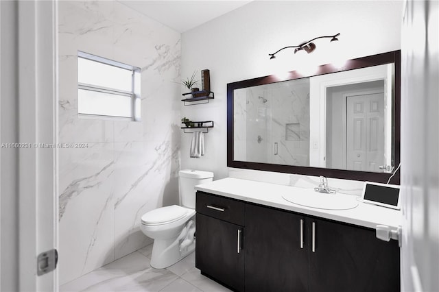 bathroom with tile walls, walk in shower, vanity, and toilet