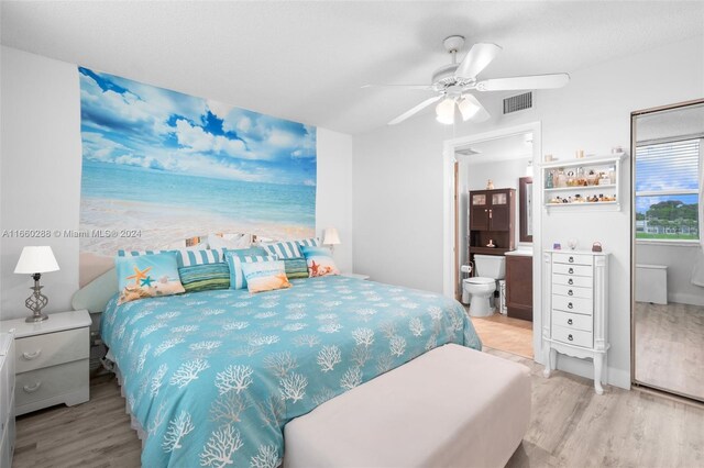 bedroom featuring connected bathroom, light hardwood / wood-style floors, and ceiling fan