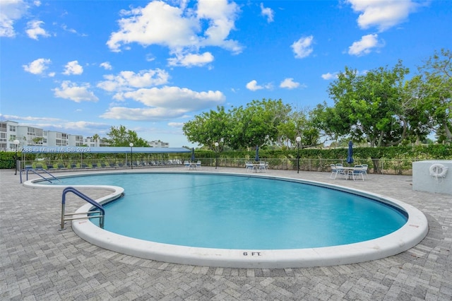 view of swimming pool featuring a patio