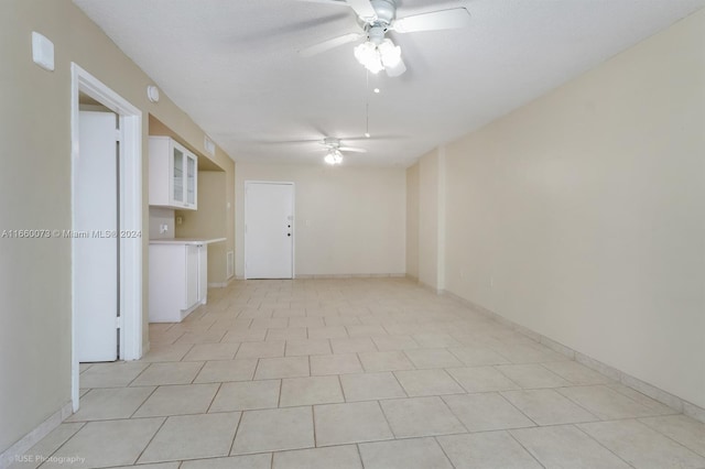 tiled spare room featuring ceiling fan and a textured ceiling