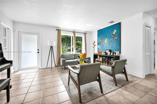 living room with light tile patterned floors and a textured ceiling