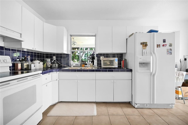 kitchen featuring backsplash, electric range, white fridge with ice dispenser, white cabinets, and tile counters