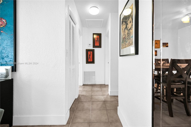 corridor with light tile patterned flooring