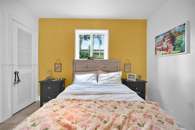 bedroom with light tile patterned floors and a closet