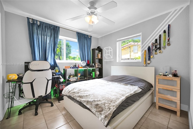 bedroom featuring multiple windows, ceiling fan, and tile patterned flooring