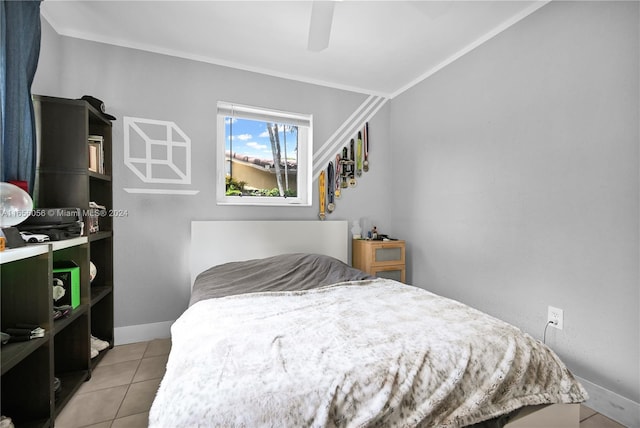 tiled bedroom featuring ceiling fan and crown molding