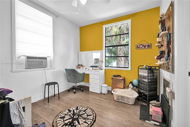 office space featuring ceiling fan, cooling unit, and light wood-type flooring