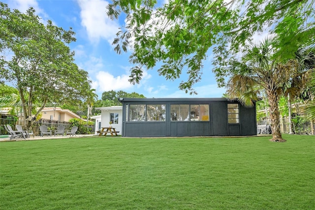 rear view of house with a yard