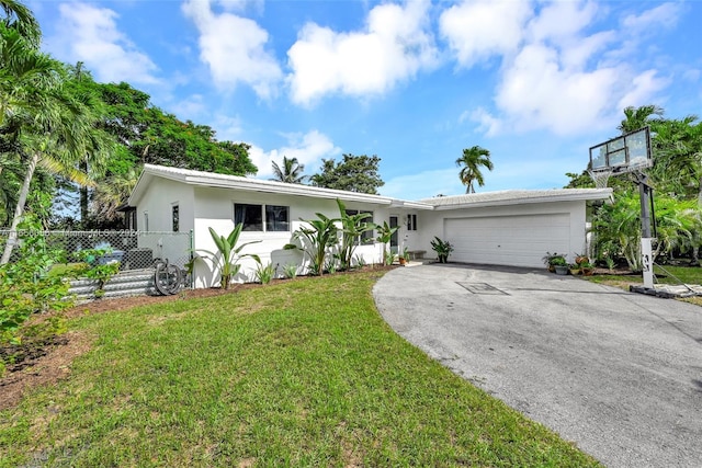 single story home with a front yard and a garage