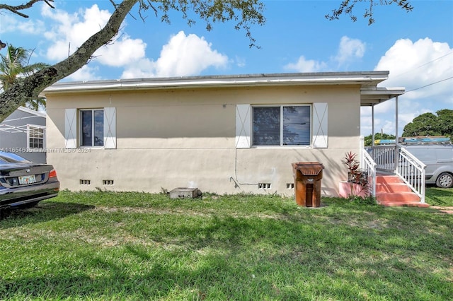 view of side of property with a yard