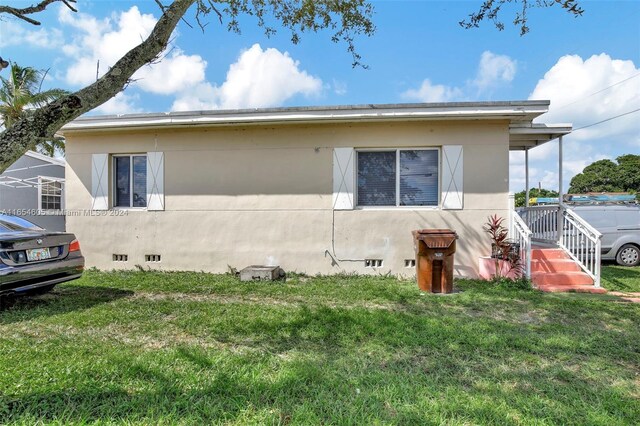 380 E 45th St, Hialeah, FL 33013 - view of side of property featuring crawl space and a yard