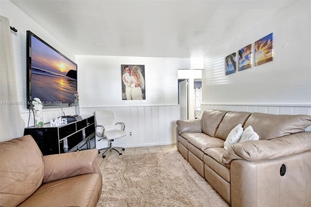 380 E 45th St, Hialeah, FL 33013 - living area with tile patterned flooring and wainscoting