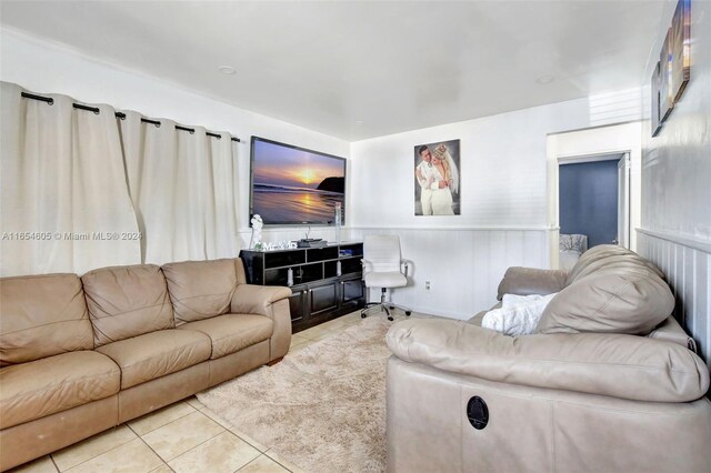 380 E 45th St, Hialeah, FL 33013 - living area with tile patterned floors and a wainscoted wall