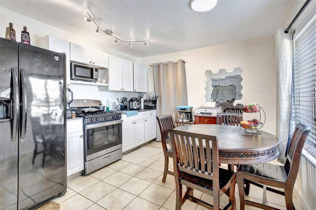 380 E 45th St, Hialeah, FL 33013 - kitchen with appliances with stainless steel finishes, white cabinetry, and light tile patterned floors