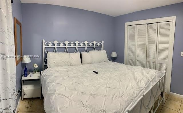 380 E 45th St, Hialeah, FL 33013 - bedroom featuring tile patterned flooring, a closet, and baseboards