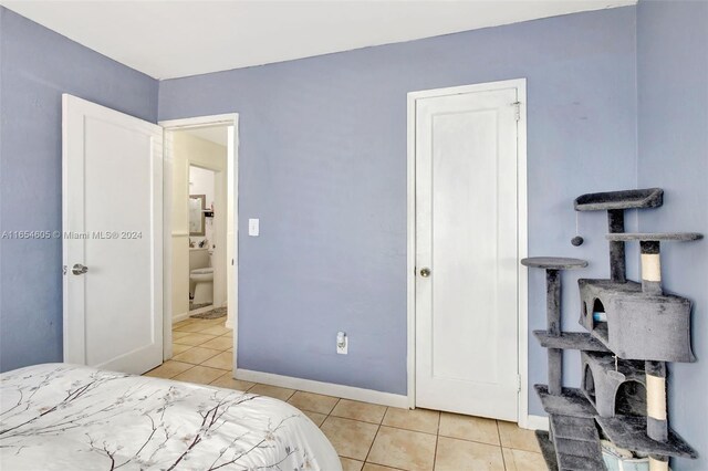 380 E 45th St, Hialeah, FL 33013 - bedroom with light tile patterned flooring and baseboards