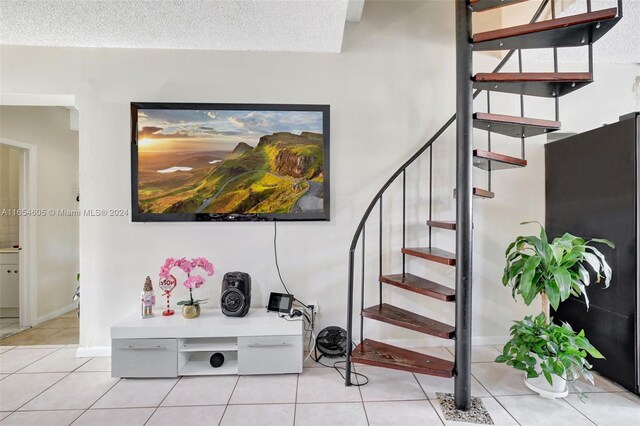 380 E 45th St, Hialeah, FL 33013 - stairway featuring tile patterned floors, baseboards, and a textured ceiling