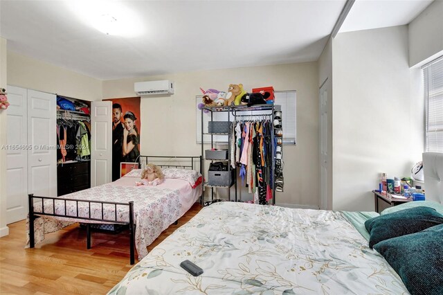 380 E 45th St, Hialeah, FL 33013 - bedroom with a wall mounted AC, wood finished floors, and a closet