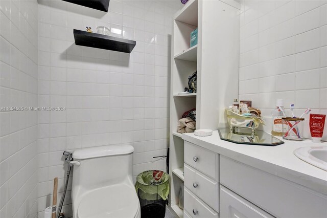 380 E 45th St, Hialeah, FL 33013 - bathroom with tile walls, toilet, and vanity