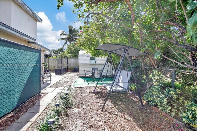 380 E 45th St, Hialeah, FL 33013 - view of patio featuring central air condition unit and an outdoor structure