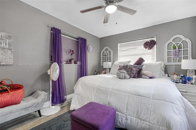 bedroom with ceiling fan and hardwood / wood-style flooring