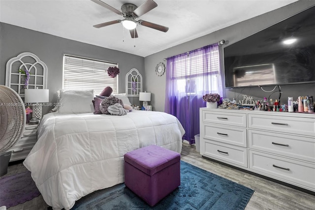 bedroom with light hardwood / wood-style flooring and ceiling fan