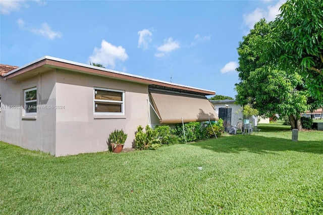 view of side of home featuring a lawn