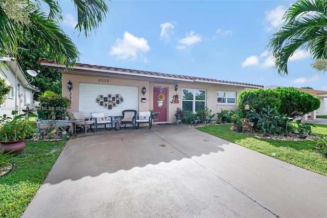 single story home with a garage and a front lawn