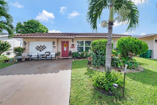 view of front of home with a garage and a front lawn