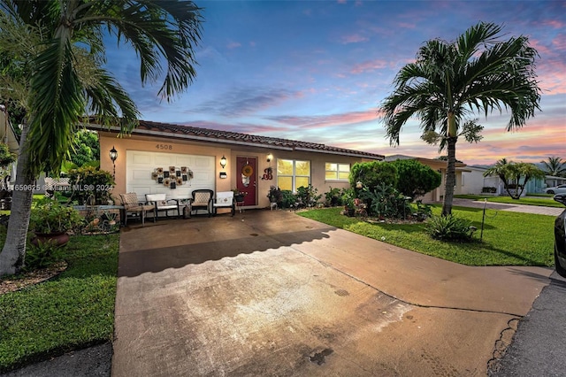 view of front facade featuring a lawn and a garage