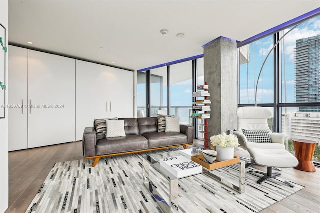 living room featuring plenty of natural light, floor to ceiling windows, and hardwood / wood-style flooring