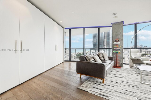 2201 Collins Ave Unit 1201, Miami Beach, FL 33139 - living area with expansive windows, a view of city, and wood-type flooring