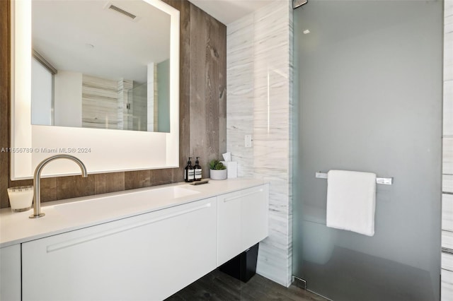 bathroom with vanity and a shower