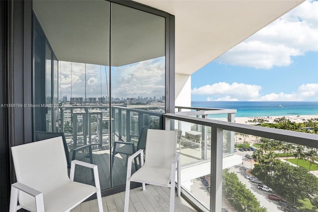 balcony with a water view and a beach view