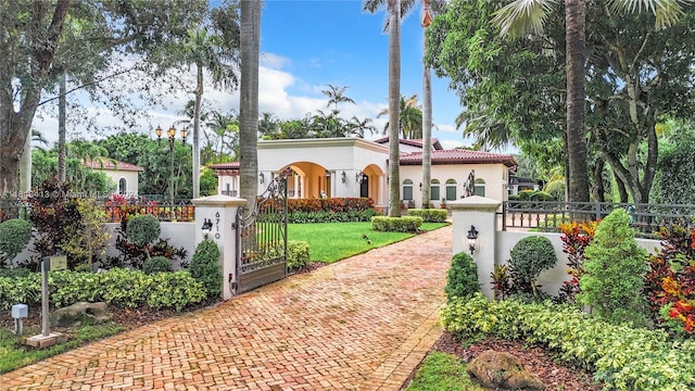 mediterranean / spanish home featuring a front yard