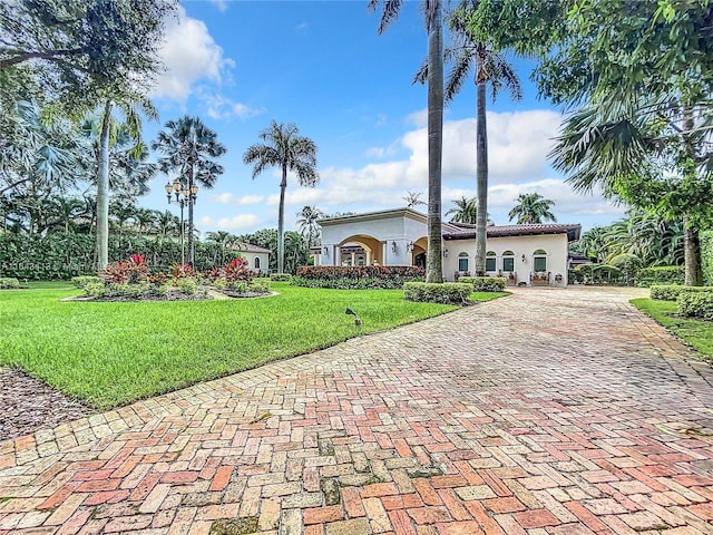 6710 SW 92nd St, Pinecrest, FL 33156 - mediterranean / spanish-style house with stucco siding, a front lawn, and decorative driveway