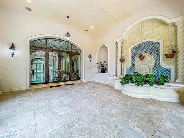 entrance foyer featuring decorative columns