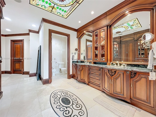 bathroom with tile patterned floors, ornamental molding, vanity, a bidet, and toilet