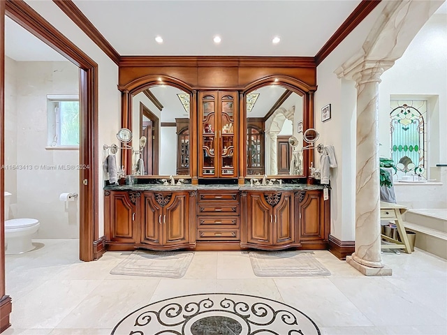 bathroom featuring vanity, decorative columns, toilet, and ornamental molding